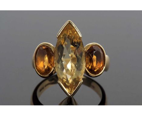 18ct gold citrine designer ring centering a Marquise shaped lemon citrine flanked by two oval cognac coloured citrines, all i