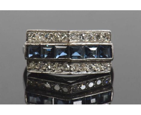 Art Deco precious metal sapphire and diamond ring, a ridge design with a central band of calibre cut sapphires, pave set betw