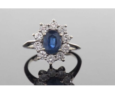 Sapphire and diamond cluster ring, the oval sapphire set within a round brilliant cut diamond surround, diamond ct wgt 1.0ct 