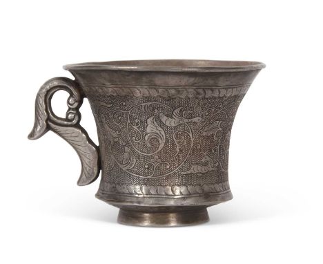 A white metal Chinese cup possibly Ming dynasty decorated with scrolling foliage with birds and mythical beasts on a stippled