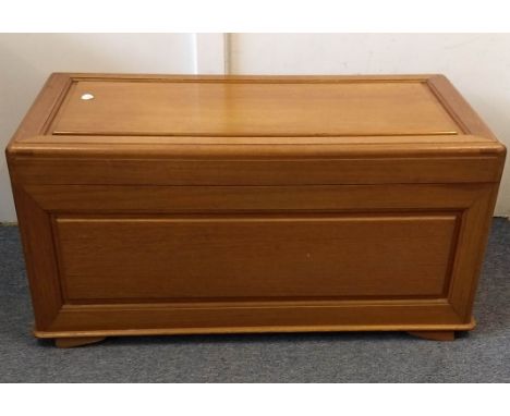 An Asian teak blanket box, hinged lid with interior sliding tray, retailers stamp to inside, top and all sides panelled, 91 c