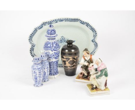 A collection of Delftware ceramics, including meat dish, plate, bottles and stoppers (af); together with a pair of Staffordsh