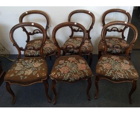 A set of six Victorian walnut balloon back chairs, floral tapestry stuff-over seats, French cabriole supports (6)