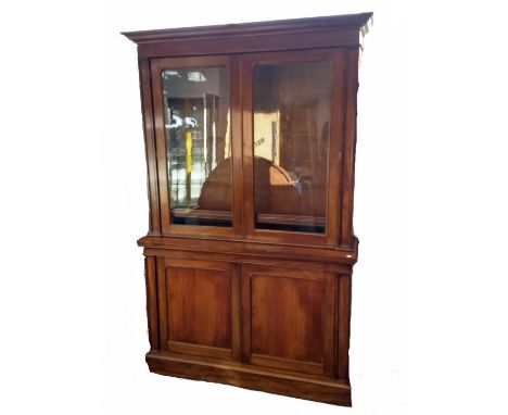 A 19th Century mahogany elevated bookcase, elevavated section with two glazed panel doors revealing adjustable shelves, above