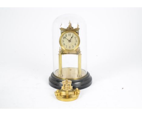 A Gustav Becker brass anniversary mantel clock, dial with Arabic numerals, signed back plate no.2005896, presented under a gl