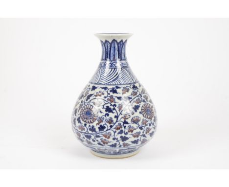 An Isnik ceramic bottle vase, decorated with arabesque floral design and multiple patterned borders, 29 cm high