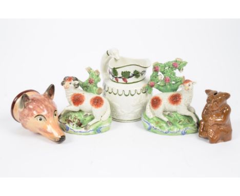 A 19th Century Staffordshire porcelain stirrup cup in the form of a fox head; together with a pair of Staffordshire models of