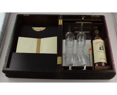 An Aberlour bottle of Single Malt Whisky, contained within a wooden box in the form of three books inscribed to the spines "W