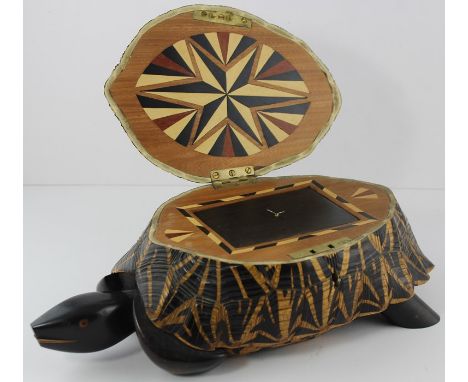 **AWAY**CANNOT SELL**A late 19th century hardwood tea caddy, realistically carved as a tortoise, the hinged top opening to re
