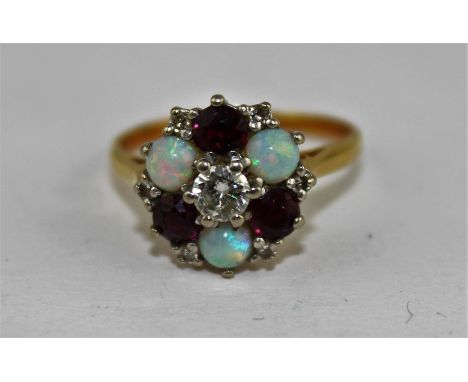 An 18ct. yellow gold, diamond, opal and ruby cluster ring, having round brilliant-cut diamond to centre (approx. 0.2 carats),