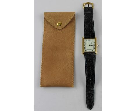 An 18ct. gold Cartier "Tank" automatic wrist watch,&nbsp;having rectangular white enamel Roman numeral dial with inside minut