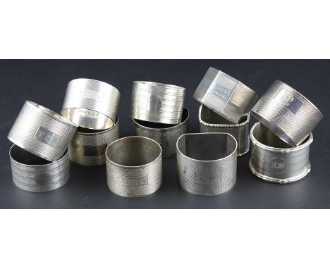 A harlequin set of twelve engine turned silver napkin rings, various dates and makers, all being approximately the same size,