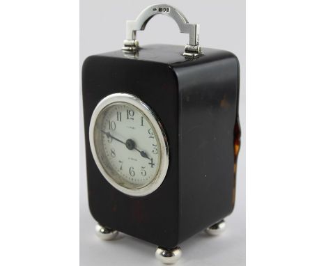 An Asprey tortoiseshell and silver mounted carriage clock, of traditional rectangular form with rounded corners, having white