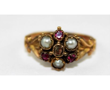 A 19th century yellow metal, pearl and ruby ring, having hexafoil shaped mount set old cut clear stone to centre with three e