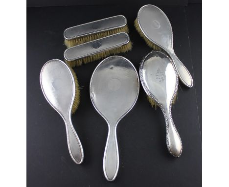 A five piece silver mounted dressing set, by Synyer &amp; Beddoes, four assayed Birmingham 1918-19, one assayed Chester (date