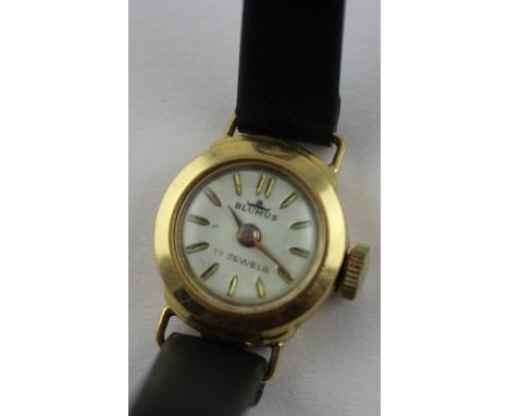 A Blumus 18ct. gold ladies' wrist watch, manual movement, having silvered circular dial with applied gold baton hour markers,