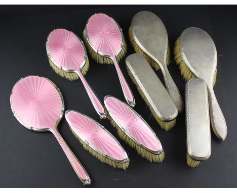 A five piece silver and pink guilloche enamel dressing set, by Walker &amp; Hall, assayed Birmingham 1913, comprising a hand 