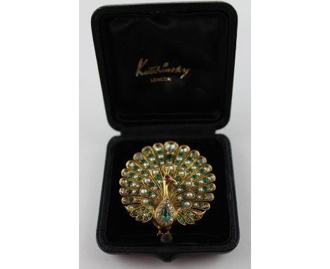 A fine yellow metal, diamond, emerald and pearl "peacock" brooch, the heavy openwork mount realistically fashioned as a male 