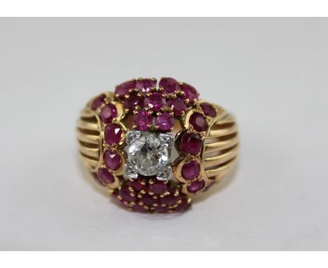 **REOFFER ETWALL JAN £200/£300**A yellow metal, diamond and ruby dress ring, having central round old cut diamond in raised s