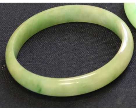 **REOFFER ETWALL JAN £60/£80**A Chinese mottled green jade child's bangle, 6.2cm diameter.