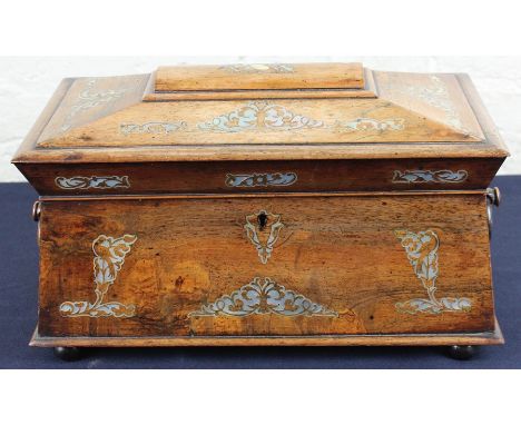 A Regency rosewood and mother of pearl inlaid sarcophagus shaped twin handled tea caddy, with two lidded canisters centered b