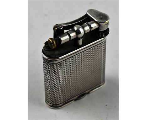 A Dunhill lift-arm silver plated table lighter, of rectangular form with curved ends and engine turned side, lift-arm signed 