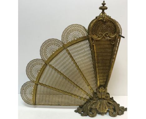 A Victorian pierced brass fan fire screen in the Rococo taste with scrolling acanthus handle / finial and base, 120 cm wide x