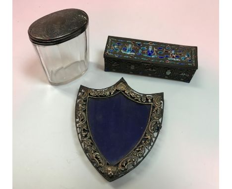 A white metal mounted shield shaped photograph frame with floral and C scroll decoration,  13.5 cm high, a Victorian silver l