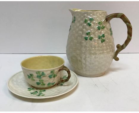 A collection of Belleek "Shamrock and basket" decorated tea wares including two teapots, three cream jugs, two sugar bowls, j