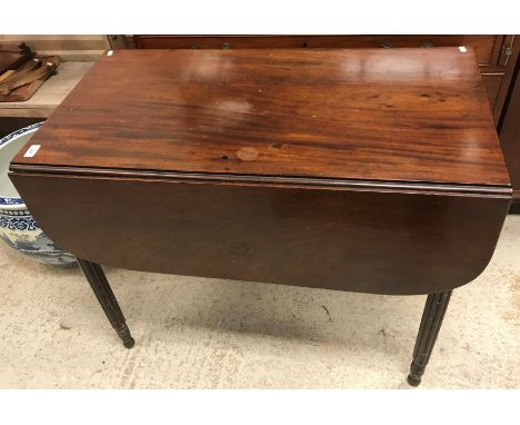 A 19th Century mahogany drop-leaf Pembroke table, the plain top with rounded leaves over a single end drawer over a dummy dra