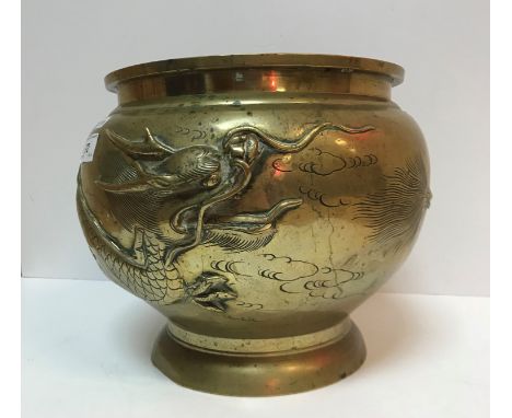 A late 19th Century Chinese brass jardiniere decorated in relief with three toed dragon bearing seal mark to base 25.5 cm dia