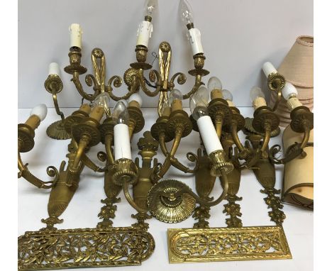 A set of six 20th Century brass twin light wall sconces on flaming torch / urn supports, 20 cm wide x 40 cm high, together wi