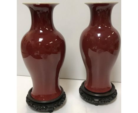 A pair of 19th Century Chinese sang de boeuf baluster shaped vases with flared rims raised on a circular foot 27.5 cm high ra