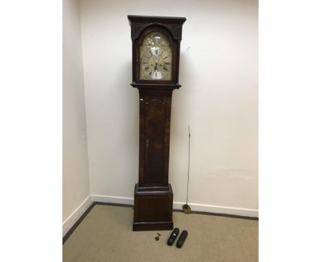 An 18th Century walnut cased long case clock, the eight day movement with silvered chapter ring, set with Roman and Arabic nu