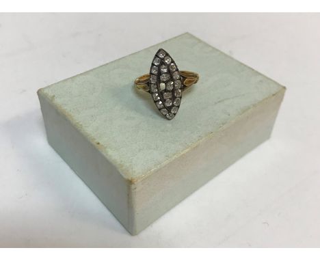 A Victorian yellow metal ring set with twenty-one diamonds in an eye shape.  Ring size OP