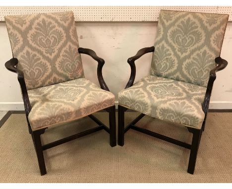 A pair of early 20th Century mahogany framed open arm chairs in the Chippendale Revival taste, the upholstered back and seat 