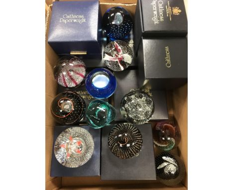 A collection of eleven various Caithness Glass paperweights including "Cauldron" (no box), "Feathers" (no box), "Marooned", "