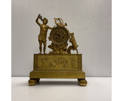 A 19th Century gilt brass cased mantel clock, the eight day movement with circular engraved dial and Roman numerals inscribed