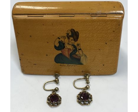 A pair of yellow metal mounted garnet set earrings together with a mauchline ware type box, the lid decorated with woman putt