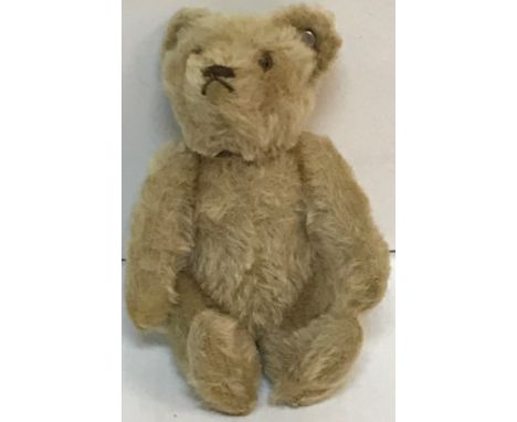 A 1950's Steiff miniature pale plush bear with jointed arms and button in ear, together with receipt from Stephanie Kay Antiq