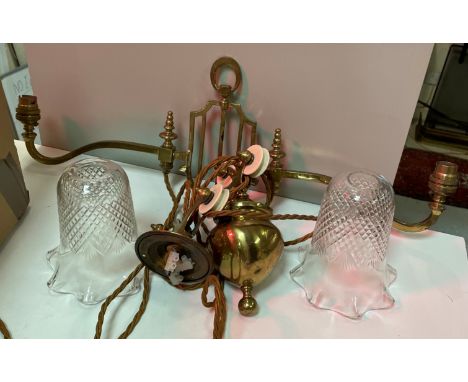 An Edwardian brass rise and fall ceiling light with pineapple cut glass shades
