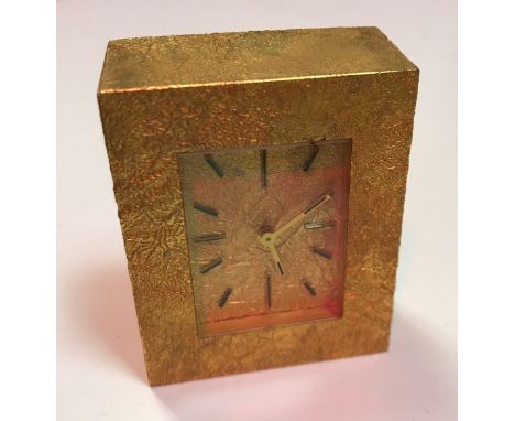 A Tiffany &amp; Co. Samorodok style silver gilt travel clock of plain rectangular form, the dial set with numeral markers, 7.