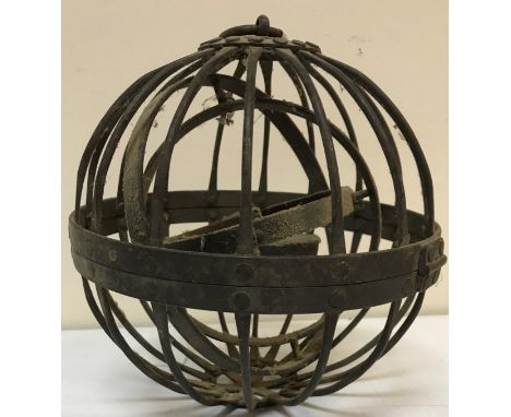 A wrought iron spherical gimbal whaling oil lamp together with a Middle Eastern brass embellished circular punch shield and a