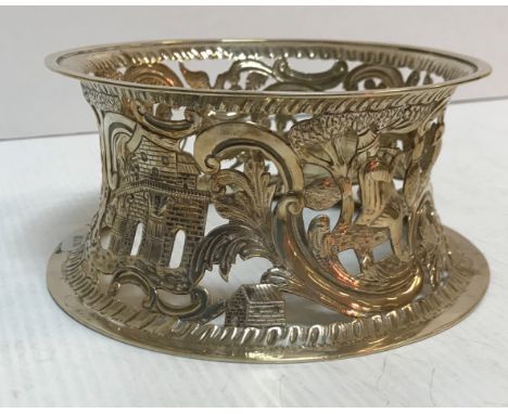 An Edwardian silver Irish dish ring with scrolling and figural decoration with buildings (by James Wakely and Frank Clarke Wh