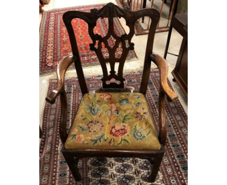 An 18th Century mahogany Provincial Chippendale style dining chair with arms added, the carved splat back above a needlework 
