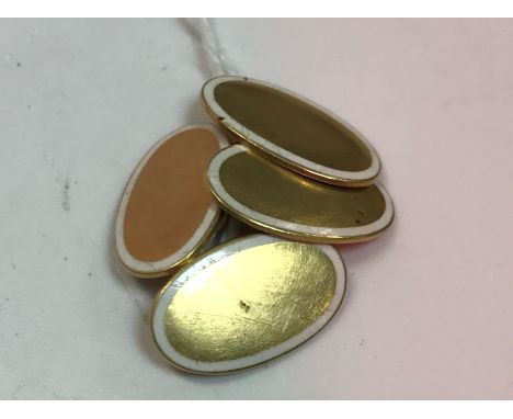A pair of 18 carat gold and white enamel decorated oval cufflinks of plain form 7.8 g