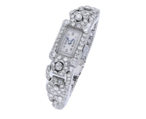 Swiss. A lady’s platinum and diamond-set Art Deco cocktail watch, circa 1930. Movement: jewelled, manual winding. Dial: silve