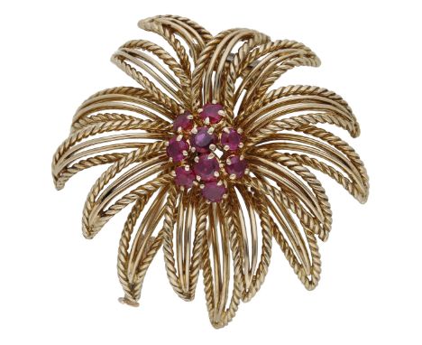A ruby brooch by Boucheron, circa 1960, the stylised spray with a circular-cut ruby cluster to the centre, within a surround 