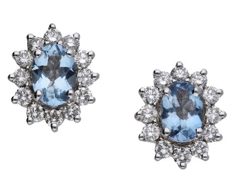 A pair of aquamarine and diamond cluster ear studs, each set with an oval-cut aquamarine within a surround of brilliant-cut d