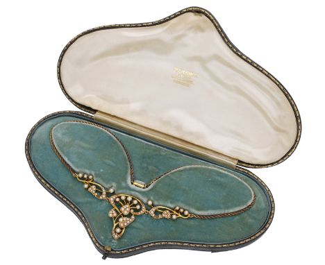 A seed pearl necklace, circa 1900, the fancy-link chain leading to a scrolling frontispiece with foliate whiplash detailing, 